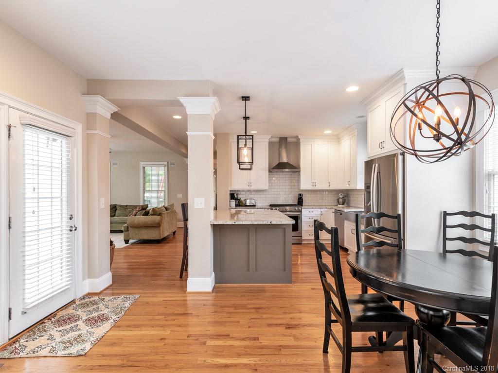 1148 Market Street Fort Mill, SC 29708 - Photo 12 of 25 a view of a dining room and livingroom with furniture wooden floor a chandelier