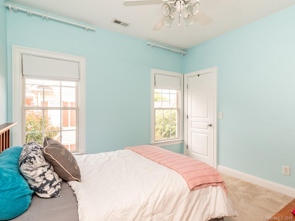 1148 Market Street Fort Mill, SC 29708 - Photo 18 of 25 a bedroom with a bed and a chandelier