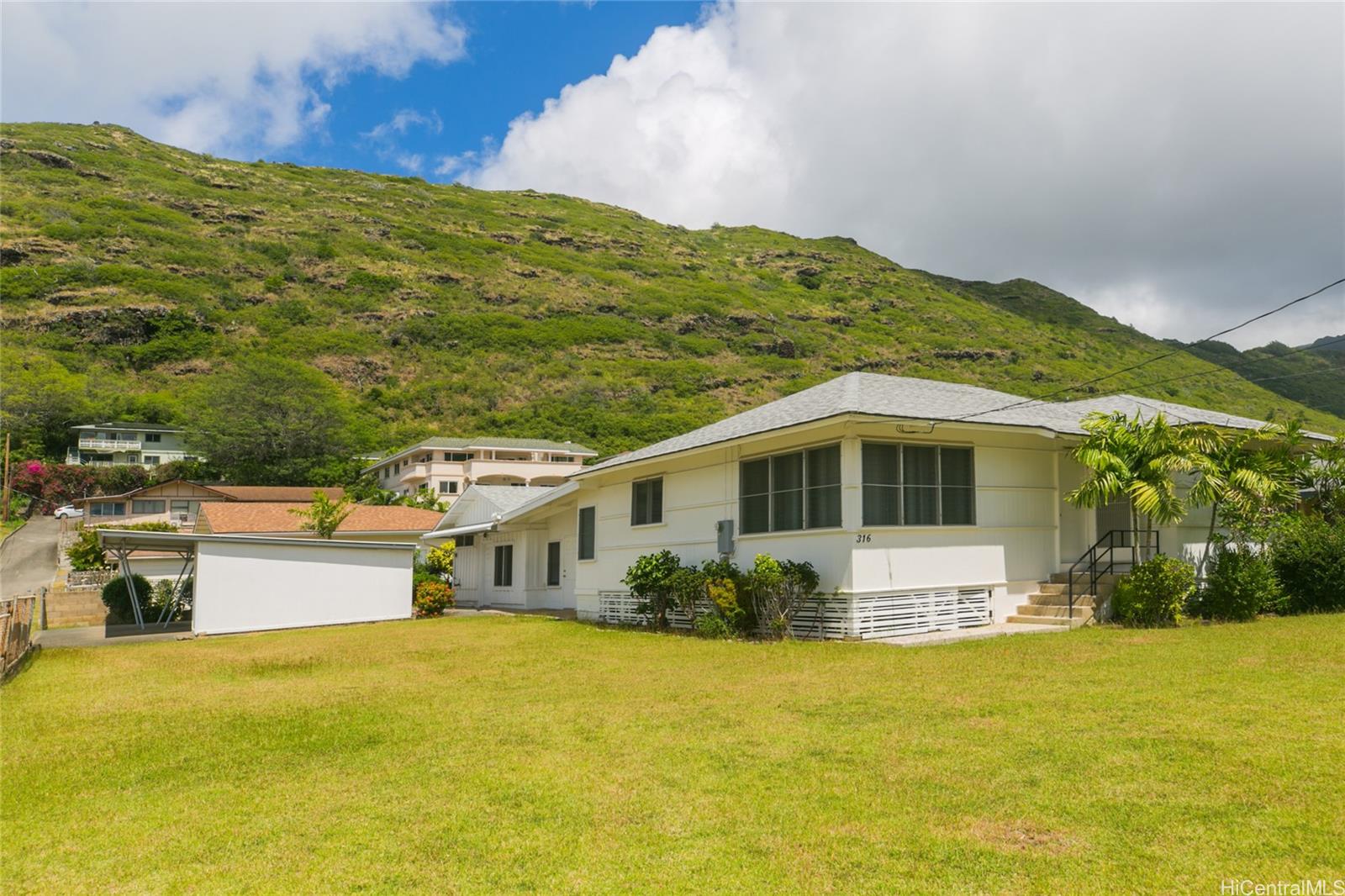 a front view of a house with a yard