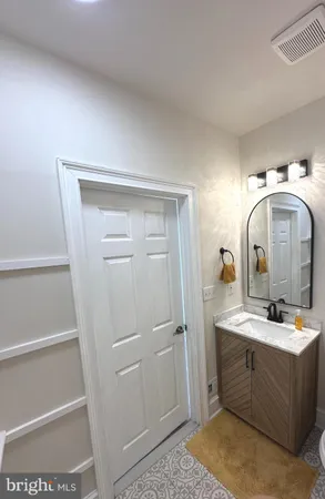 a bathroom with a sink and mirror with toilet