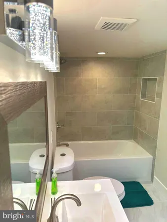a bath tub sitting next to a bathroom sink