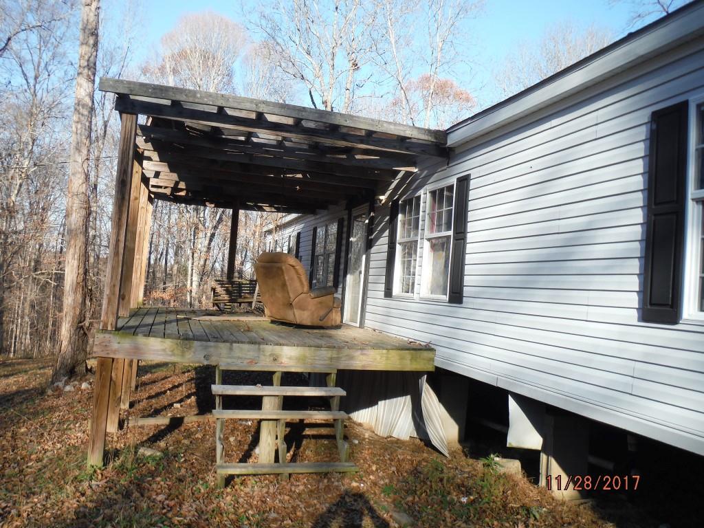 599 Lucas Road Dickson, TN 37055 - Photo 2 of 12 a view of balcony with chairs and wooden fence