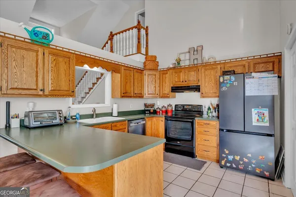 a kitchen with stainless steel appliances granite countertop a sink and cabinets