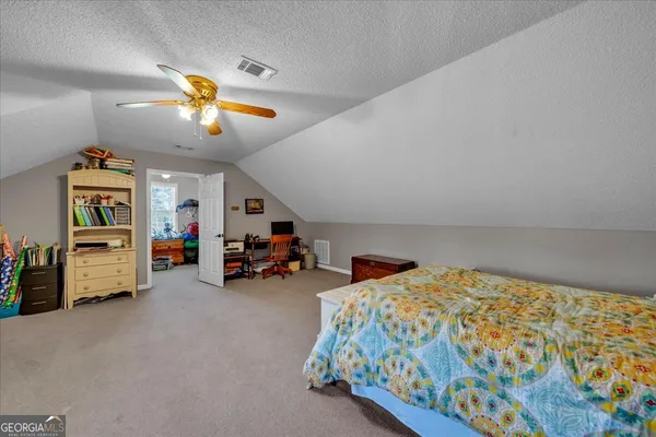 a bedroom with furniture and a chandelier