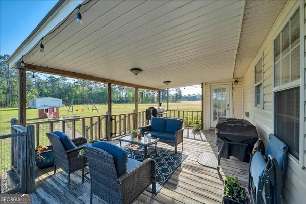 a living room with furniture and floor to ceiling windows