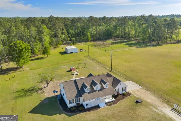 a view of a swimming pool with a yard