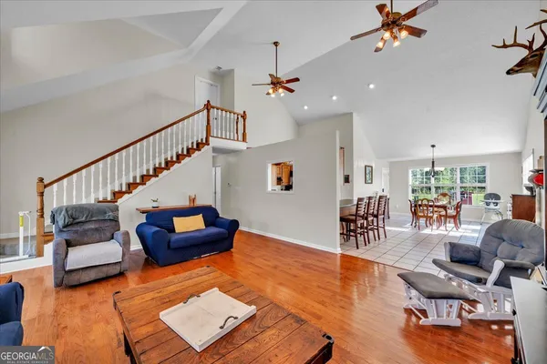 a living room with furniture and wooden floor