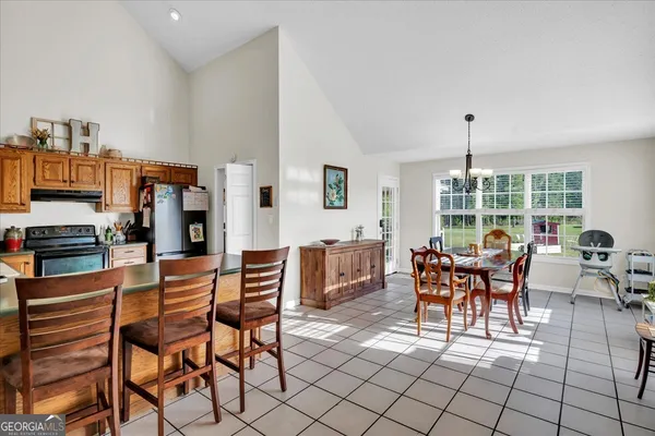 a dining room with furniture and wooden floor