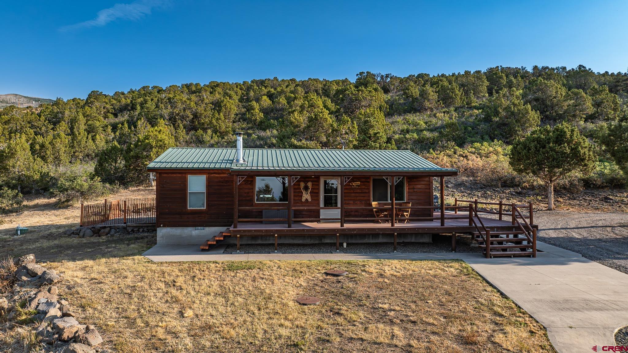 21578 Highway 65 Cedaredge, CO 81413 - Photo 13 of 45 a front view of a house with a garden