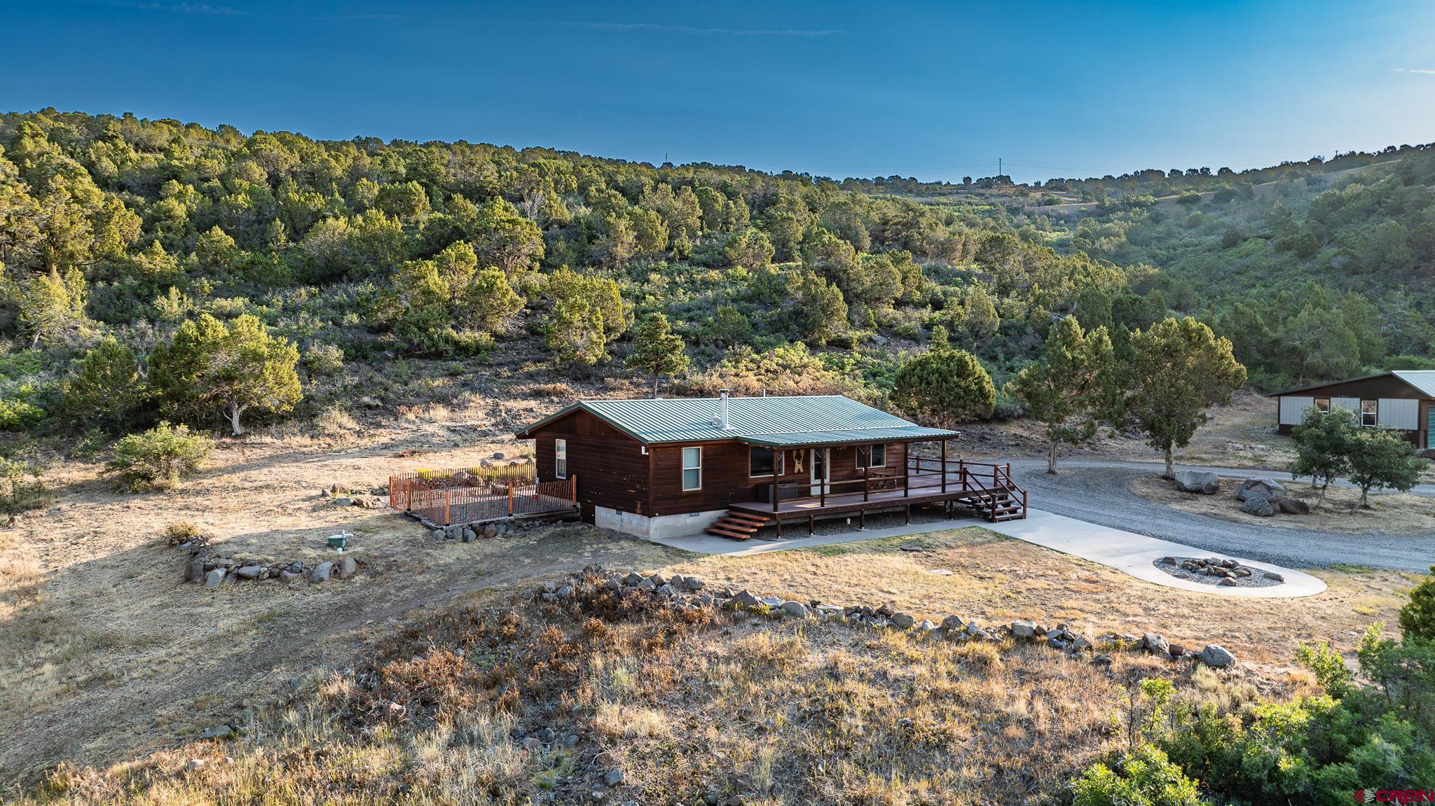 21578 Highway 65 Cedaredge, CO 81413 - Photo 2 of 45 a view of a house with a yard and sitting area