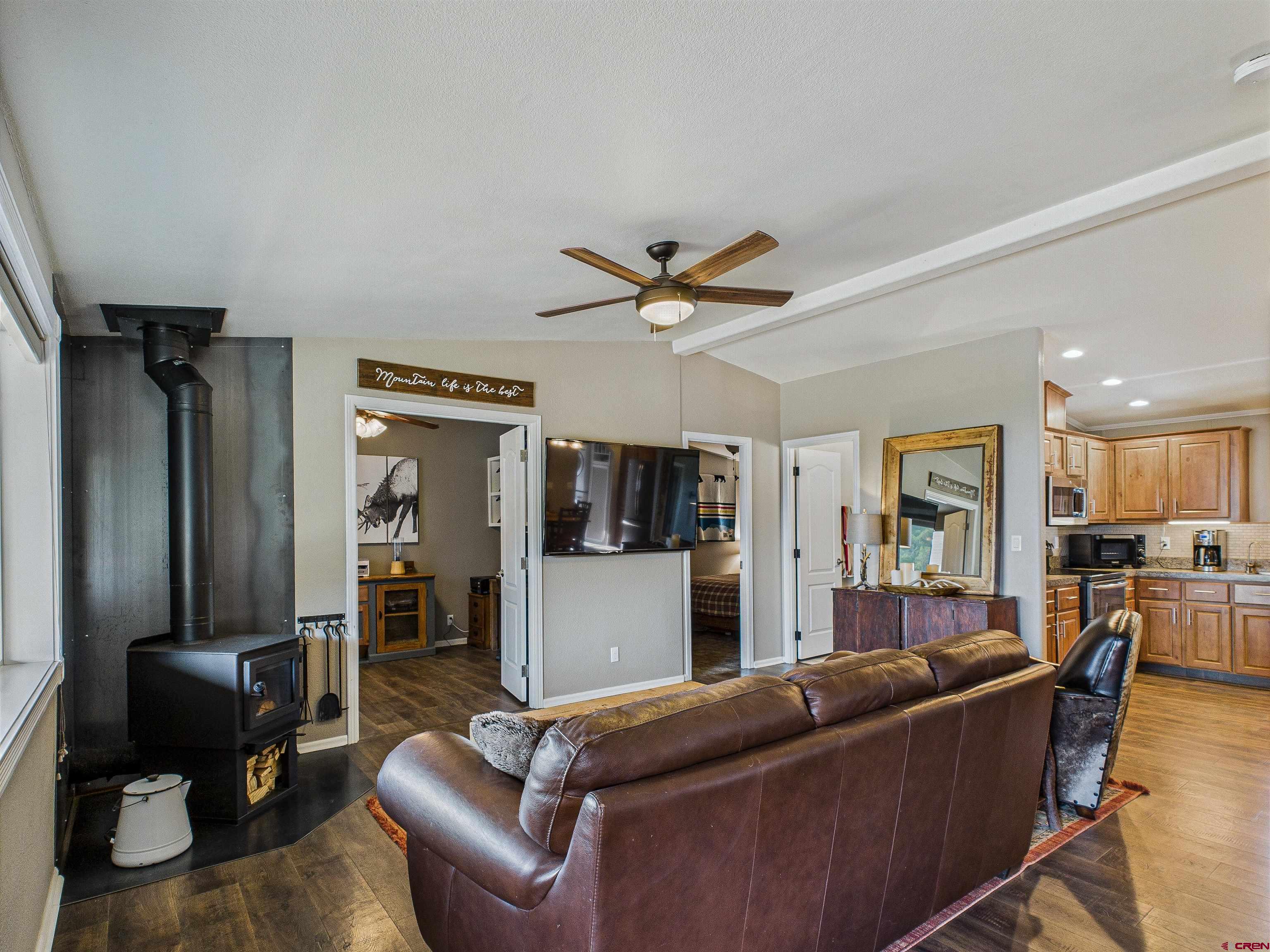 21578 Highway 65 Cedaredge, CO 81413 - Photo 24 of 45 a living room with furniture and a flat screen tv