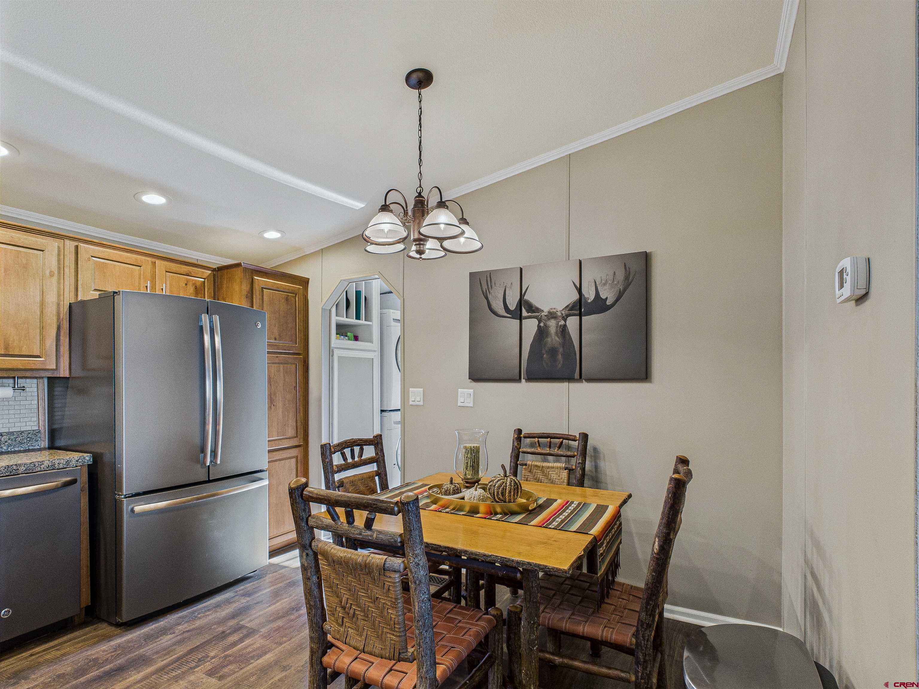 21578 Highway 65 Cedaredge, CO 81413 - Photo 26 of 45 a view of a dining room with furniture wooden floor and chandelier
