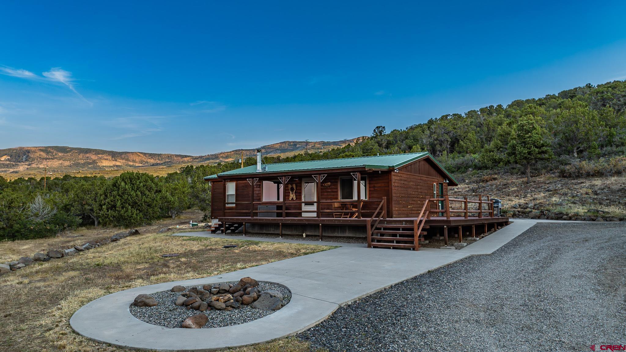 21578 Highway 65 Cedaredge, CO 81413 - Photo 3 of 45 front view of a house with a yard