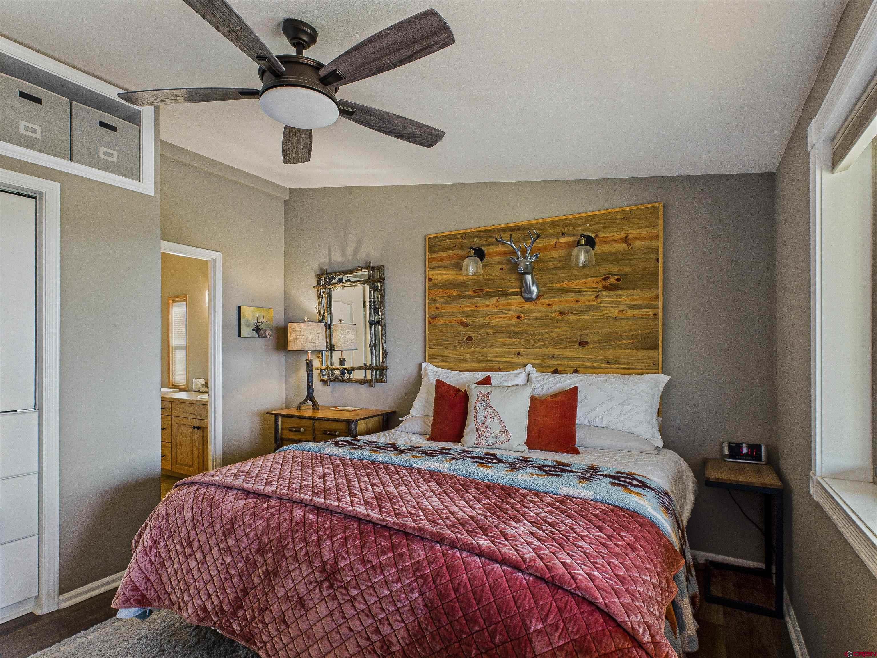 21578 Highway 65 Cedaredge, CO 81413 - Photo 35 of 45 a bedroom with a bed and a chandelier