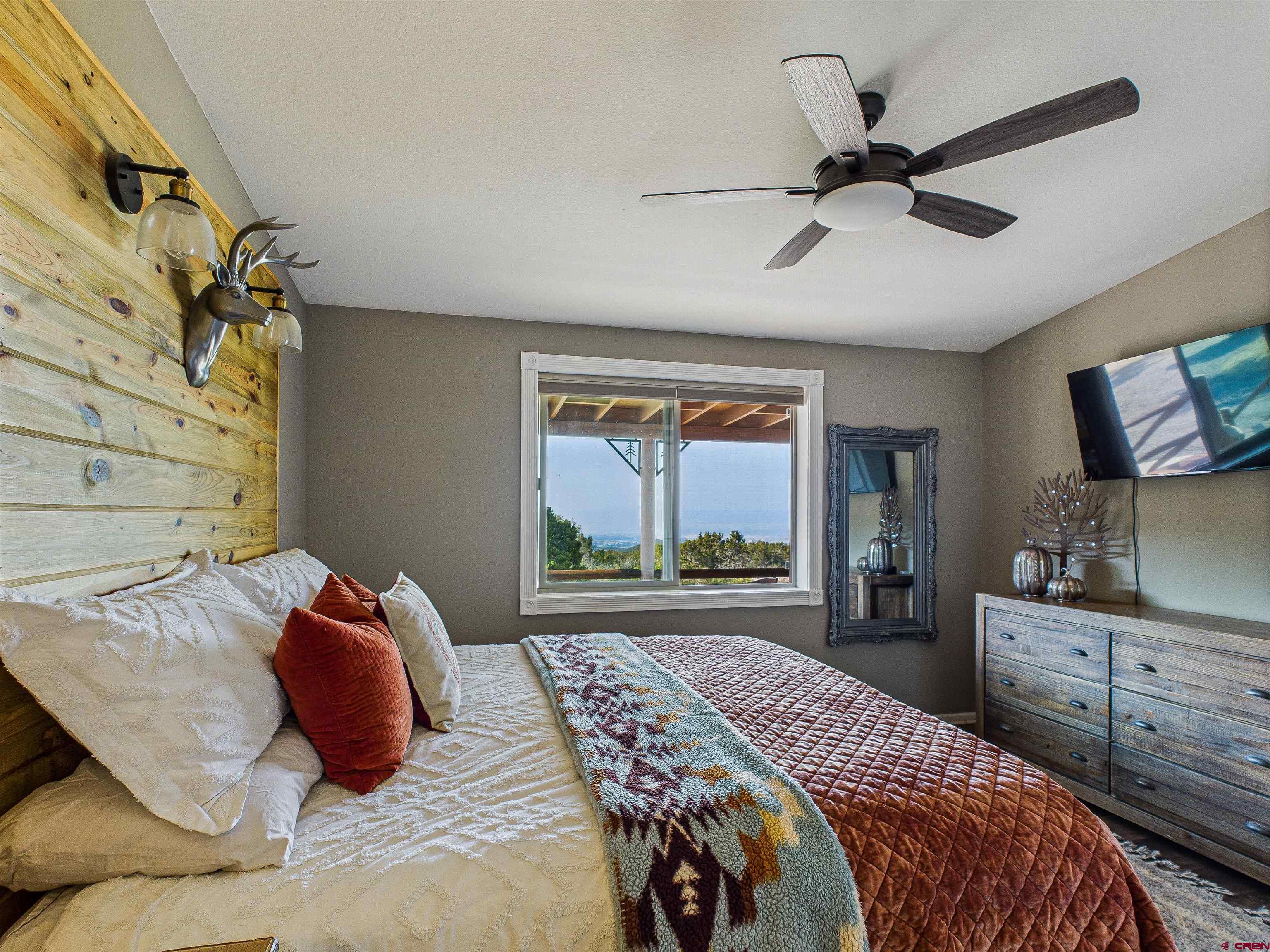 21578 Highway 65 Cedaredge, CO 81413 - Photo 36 of 45 a bedroom with a large bed and a window
