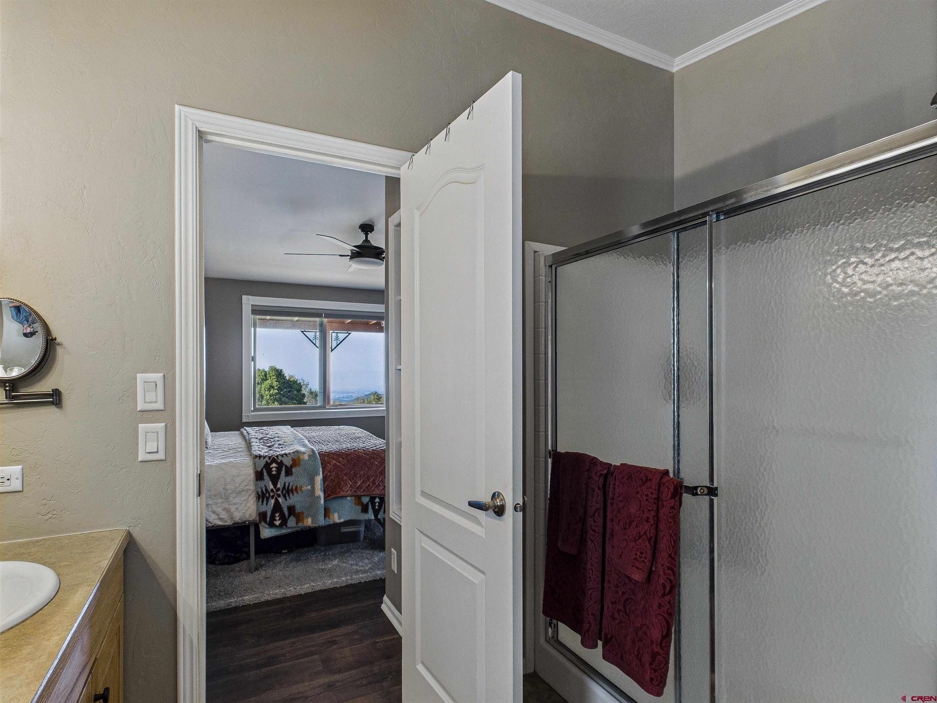 21578 Highway 65 Cedaredge, CO 81413 - Photo 38 of 45 a en suite bathroom with a sink a toilet and a shower