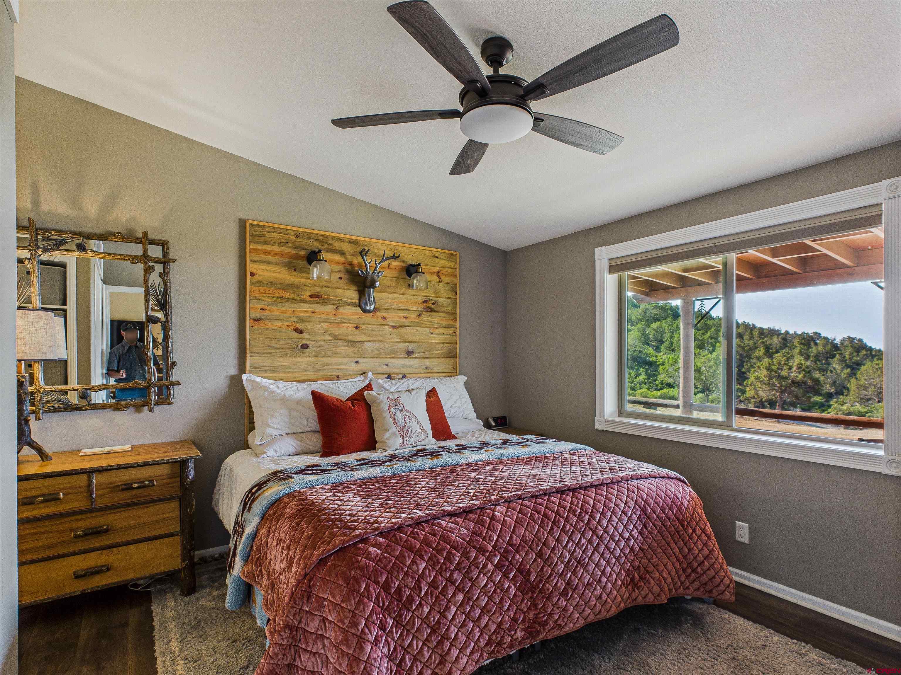 21578 Highway 65 Cedaredge, CO 81413 - Photo 39 of 45 a bedroom with a large bed and a large window