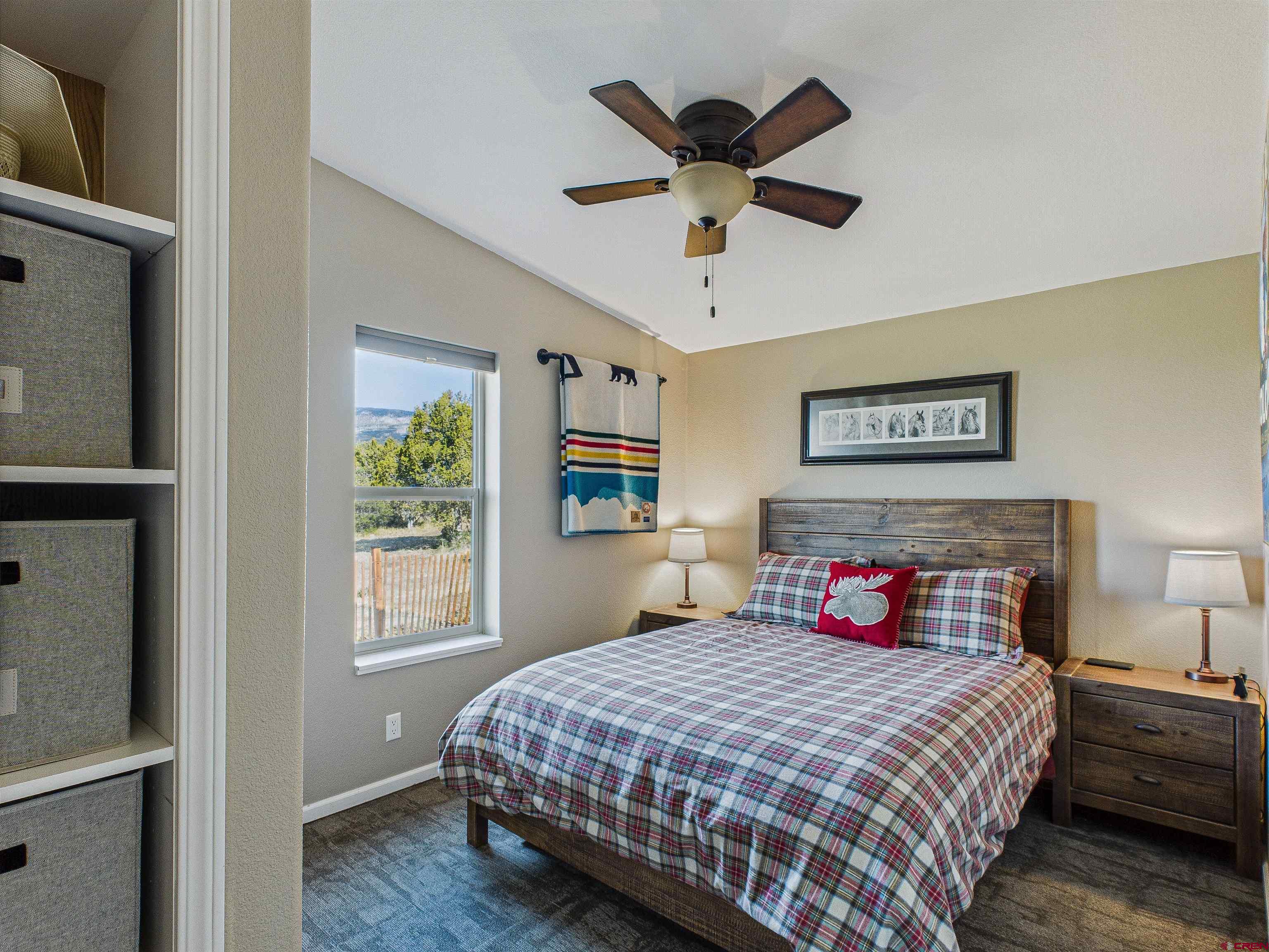 21578 Highway 65 Cedaredge, CO 81413 - Photo 40 of 45 a bedroom with a large bed and a large window