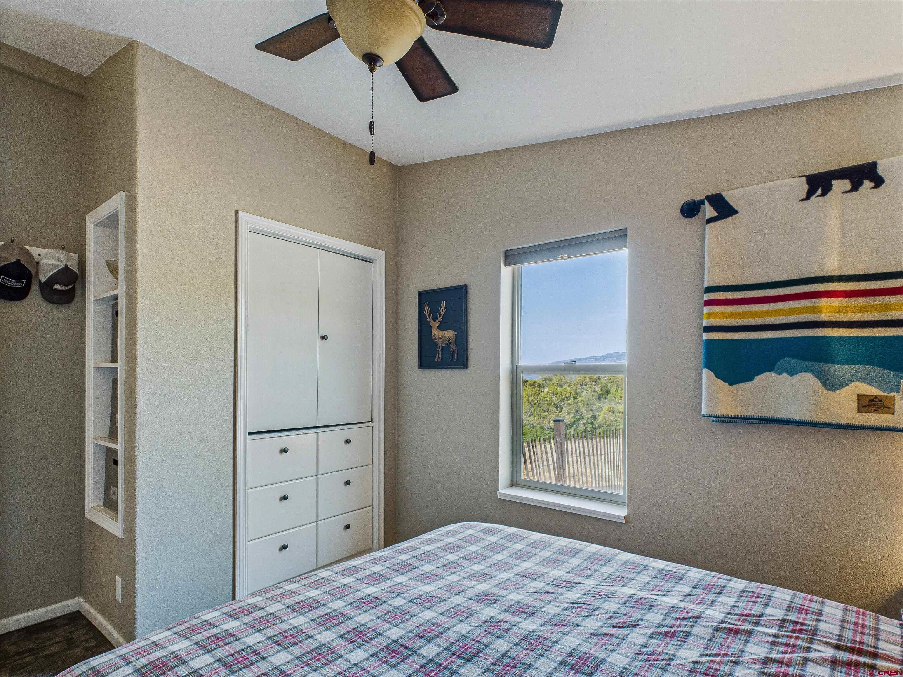 21578 Highway 65 Cedaredge, CO 81413 - Photo 42 of 45 a bedroom with a bed and a dresser