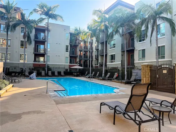a swimming pool with outdoor seating and yard