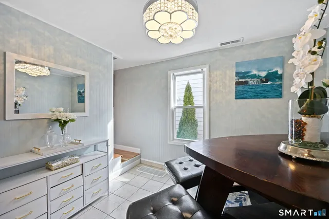 a living room with kitchen island furniture and a potted plant