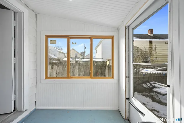 a view of a room that has a bed and a large window with balcony view