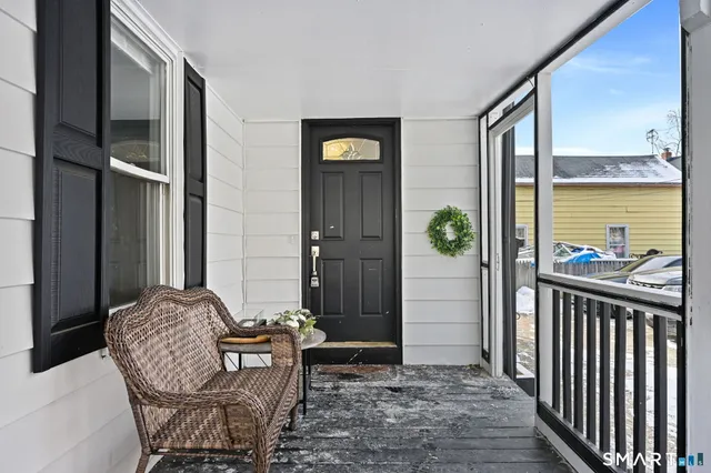 a view of balcony filled with furniture