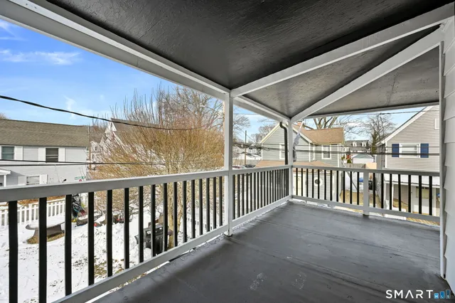 a view of a porch with wooden floor and fence