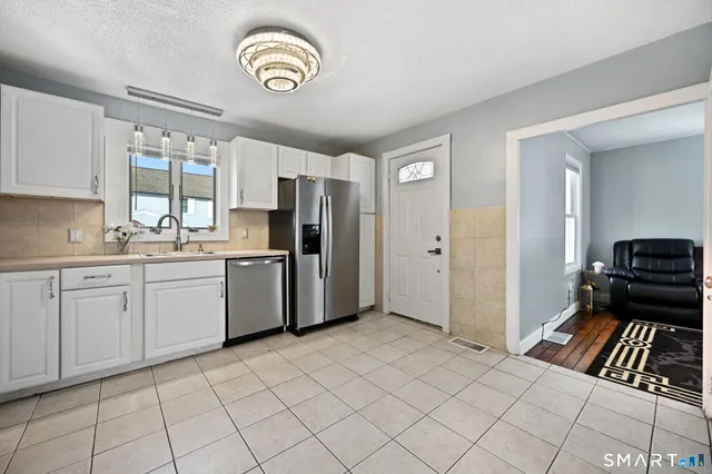 a kitchen with a refrigerator a sink and dishwasher