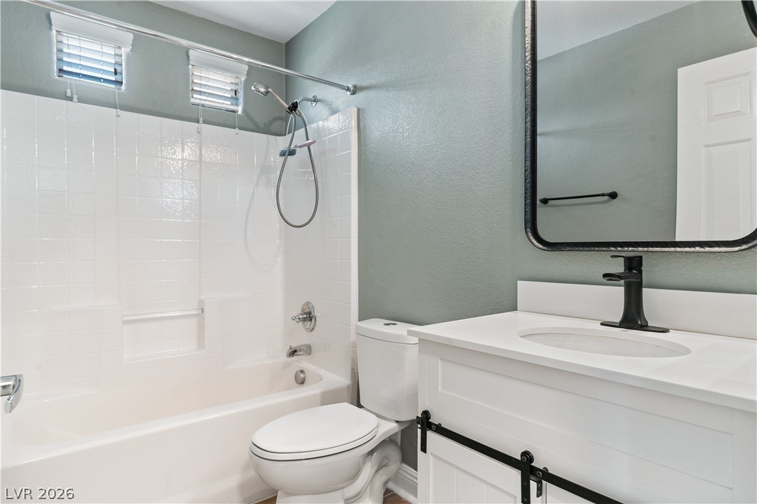 1328 Spice Ridge Court Henderson, NV 89012 - Photo 31 of 51 This clean and inviting secondary bathroom features a modern vanity and a classic tub-shower combination.