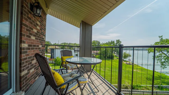 a view of a balcony with furniture and floor to ceiling window