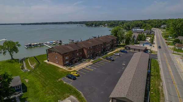 an aerial view of a house with a lake view