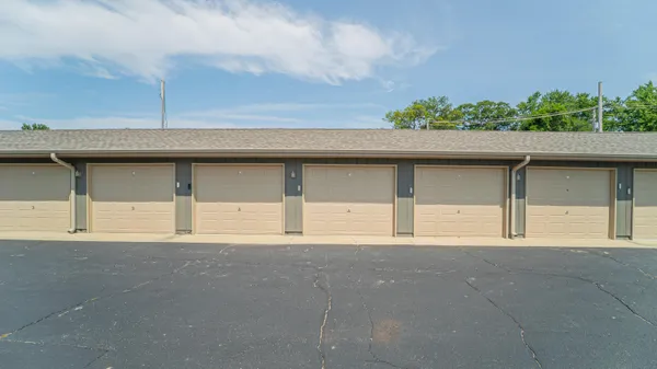 wooden floor fireplace and windows in an empty room