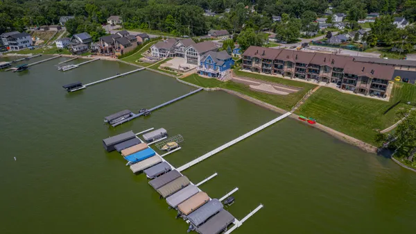 an empty room with wooden floor and a fireplace