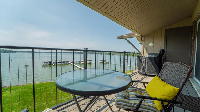 a balcony with table and chairs