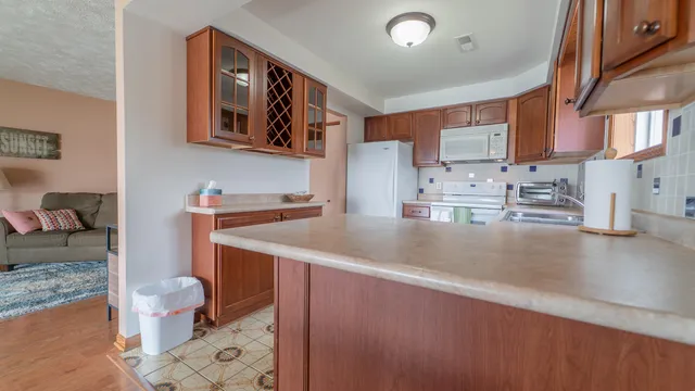 a kitchen with stainless steel appliances granite countertop a sink stove and cabinets