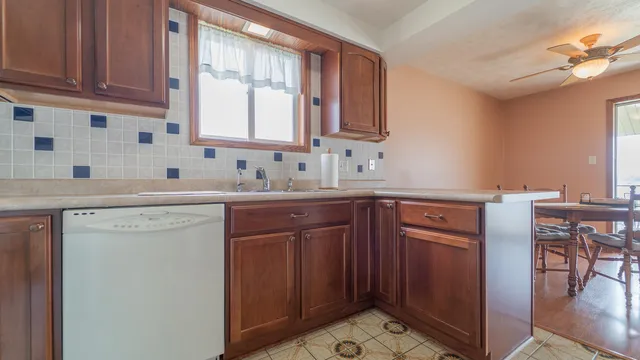 a kitchen with a sink cabinets and window