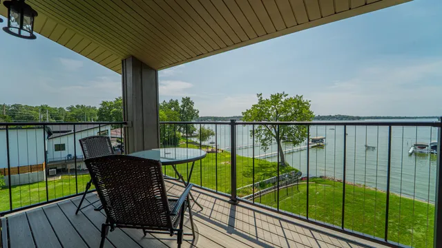 a view of a chairs and table in the balcony