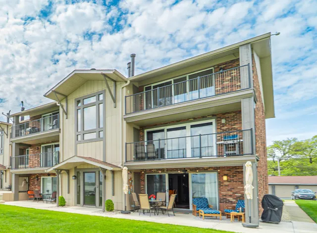 a front view of a residential apartment building with a yard