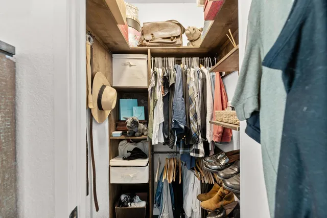 a bath room with a table chairs and a chandelier