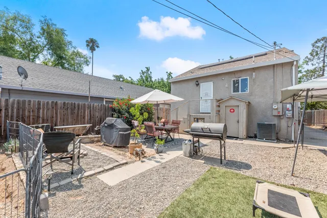 a view of a patio with a table and chairs under an umbrella