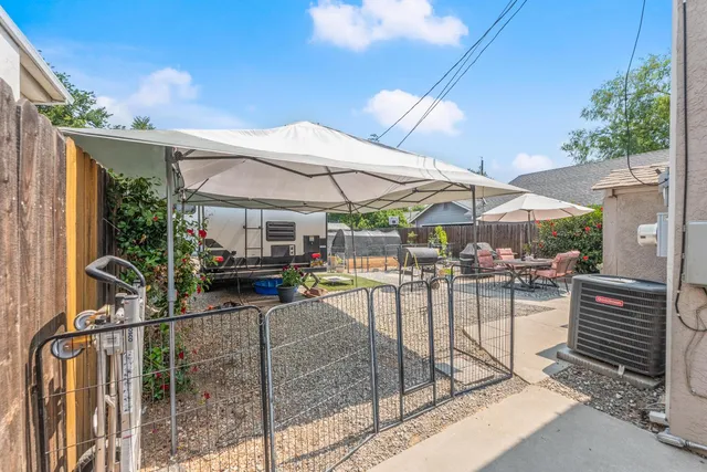 a view of a backyard with furniture and a fire pit