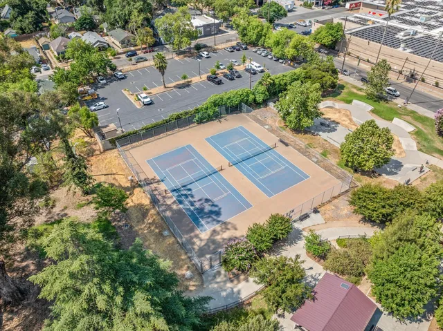 a view of a patio with couches table and chairs and potted plants