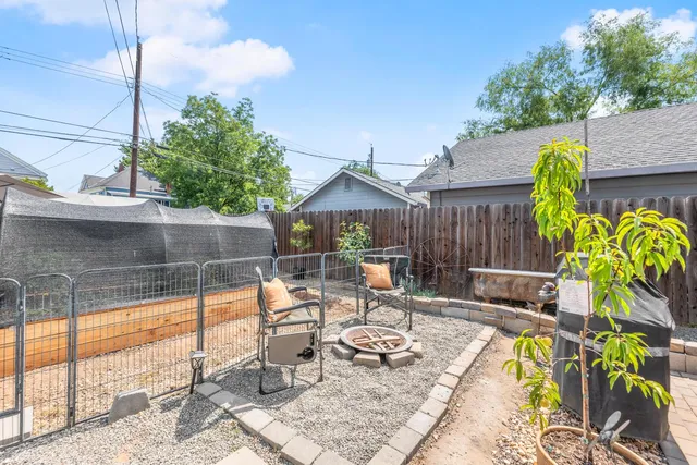 a front view of a house with a yard and potted plants
