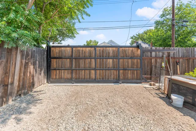 a living room with a white furniture cabinets and a kitchen space