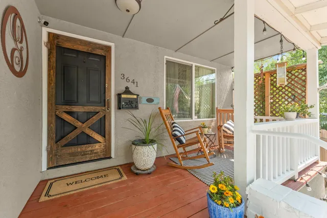 a view of a balcony with chair and floor to ceiling window