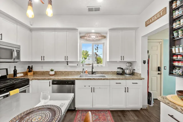 a kitchen with a stove a sink and a refrigerator