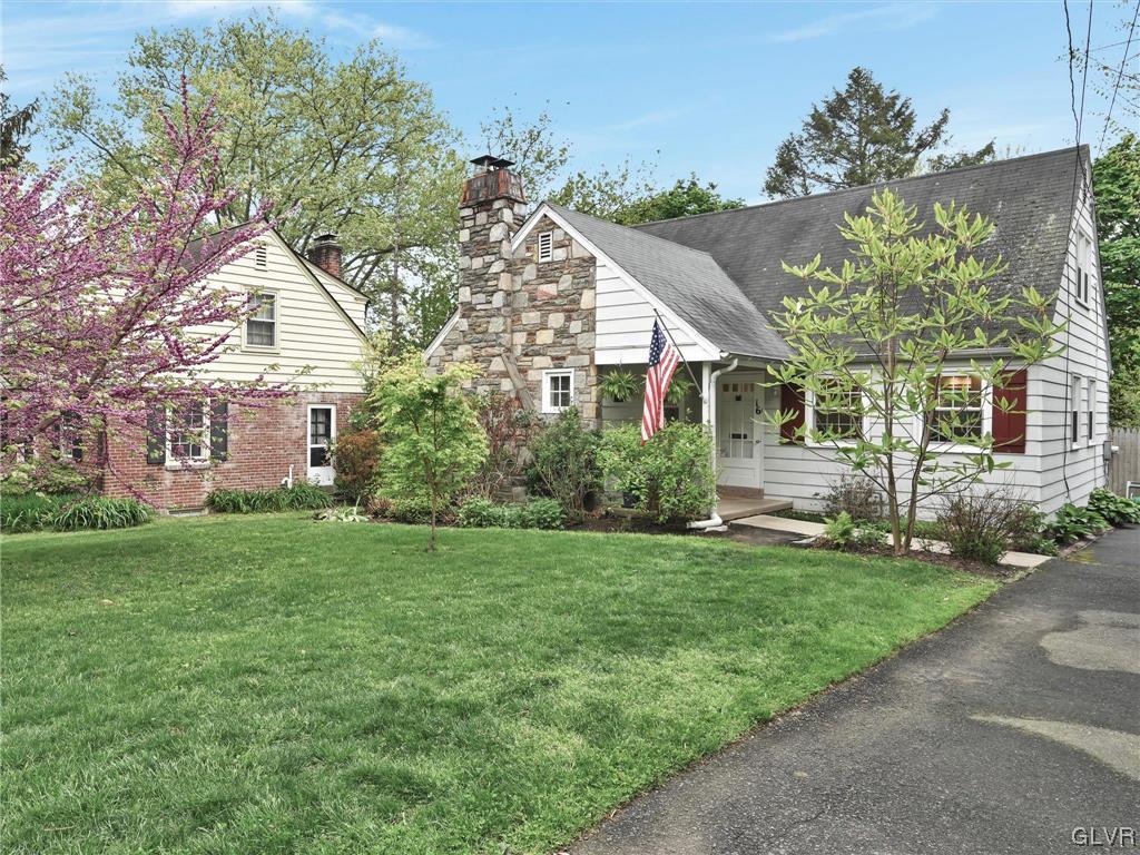 16 Hewett Road Cheltenham, PA 19095 - Photo 1 of 19 a front view of a house with a garden and yard