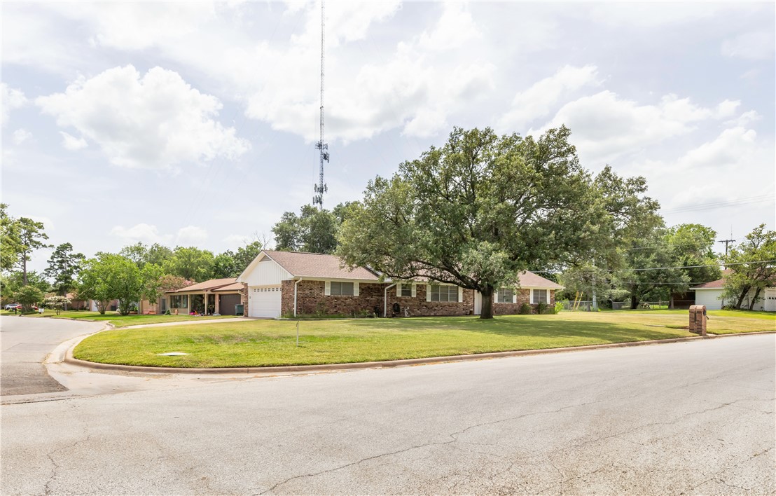 3716 Tanglewood Drive Bryan, TX 77802 - Photo 2 of 25 a view of a house with a big yard and large trees