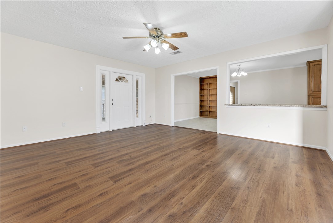 3716 Tanglewood Drive Bryan, TX 77802 - Photo 8 of 25 wooden floor in an empty room with a window